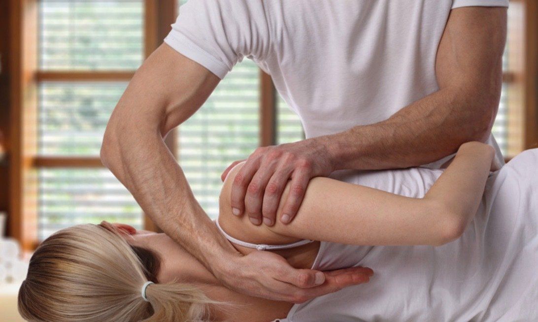 A man is giving a woman a massage in a room.