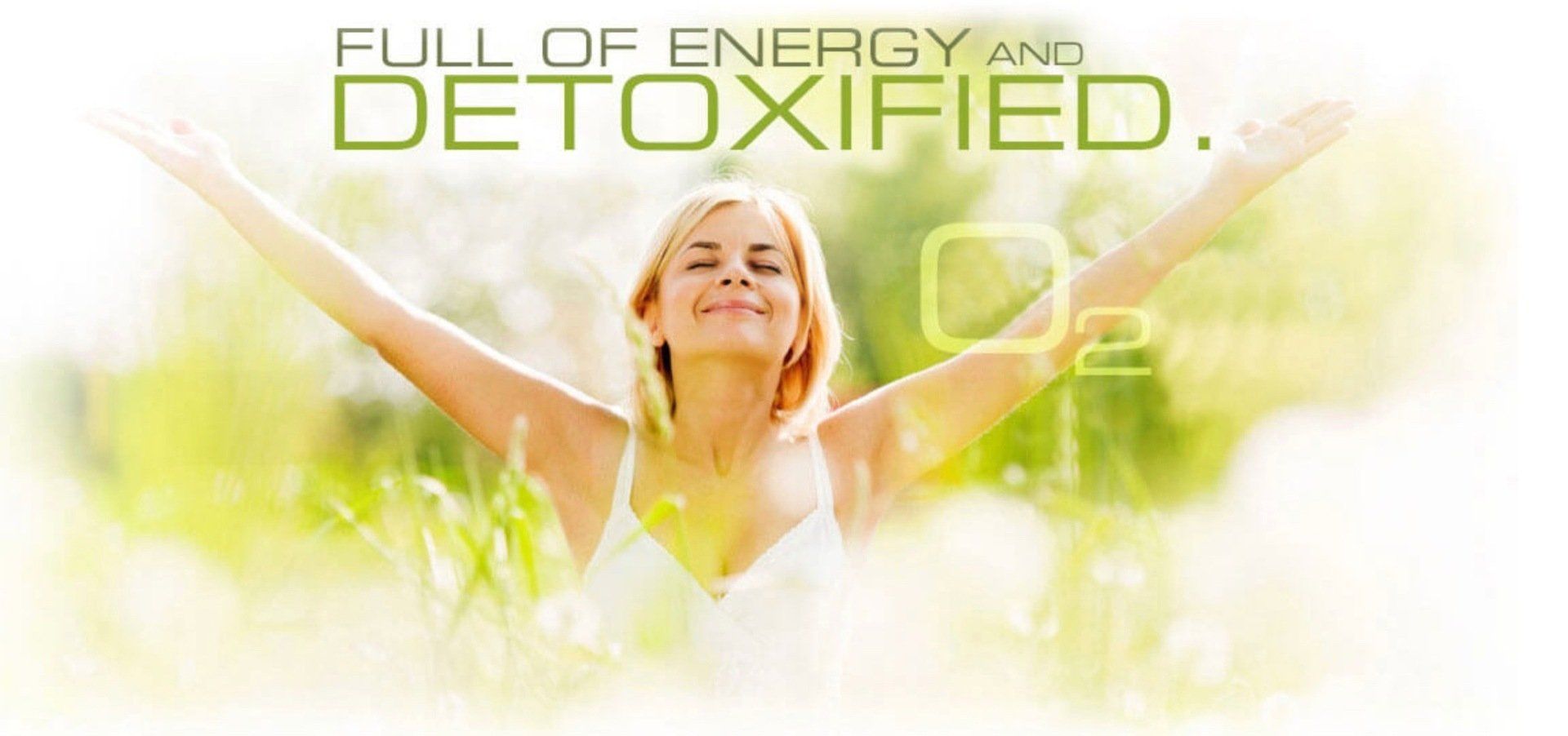 A woman is standing in the grass with her arms outstretched.