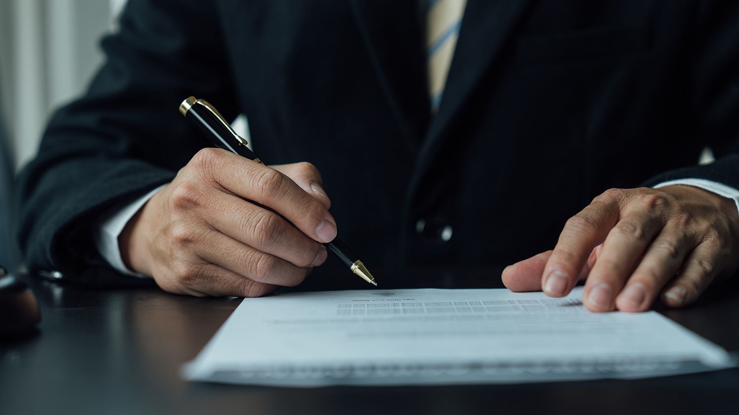 A wills and trust attorney reviews his client's contract for estate planning.
