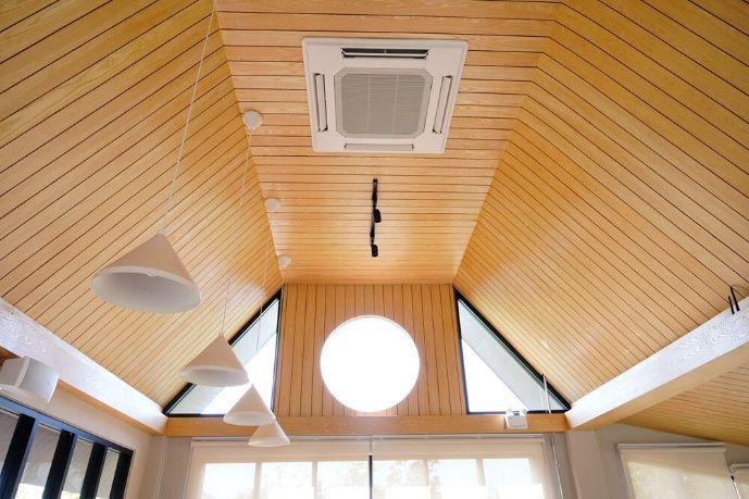 A Room With A Wooden Ceiling And A Round Window — Cool & Secure In Maroochydore, QLD