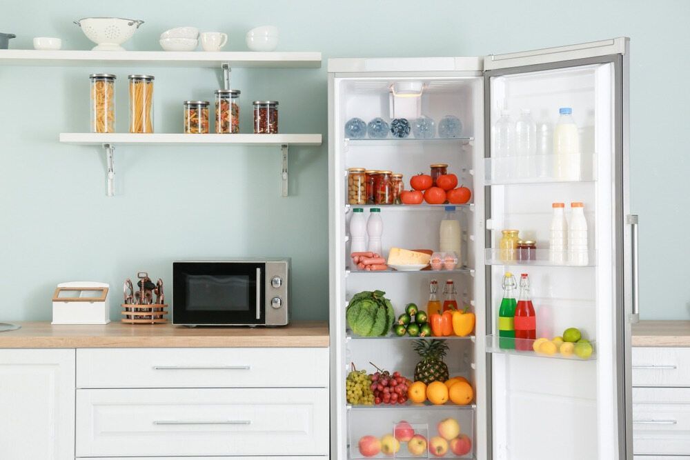 A Kitchen With A Refrigerator Filled With Fruits And Vegetables And A Microwave — Cool & Secure In Buderim, QLD