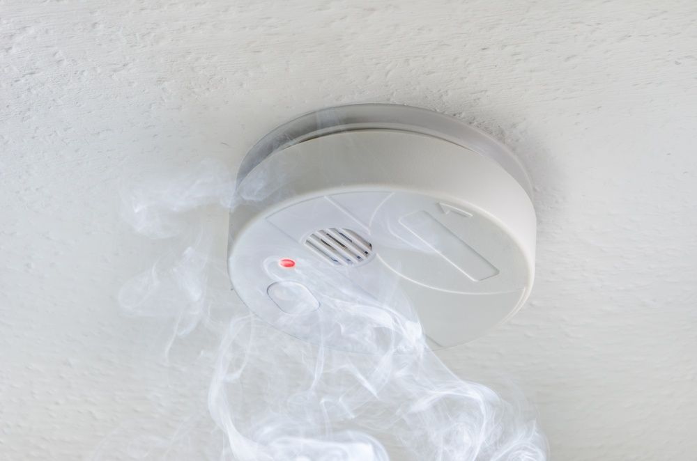 A Smoke Detector Is Hanging From The Ceiling And Smoke Is Coming Out Of It — Cool & Secure In Buderim, QLD