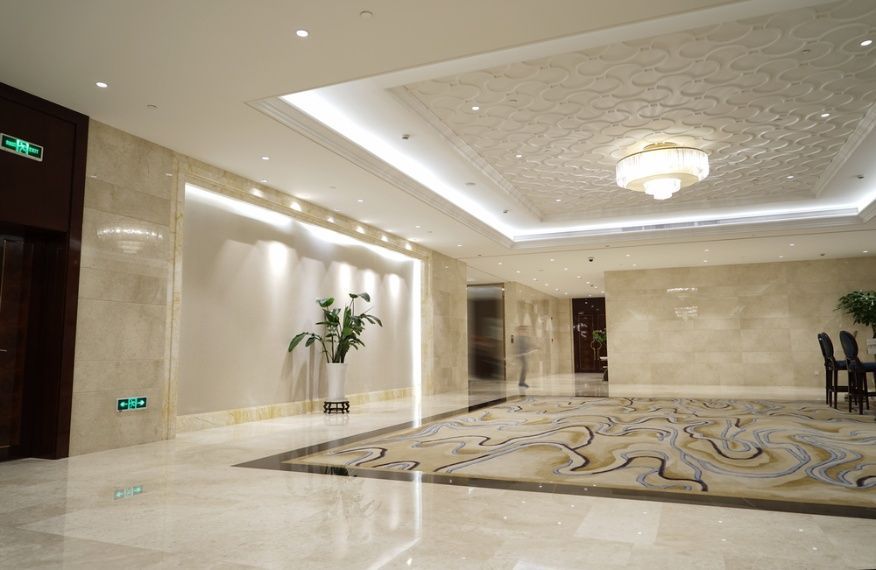 A Large Hallway With A Rug On The Floor And A Chandelier On The Ceiling — Cool & Secure In Maroochydore, QLD