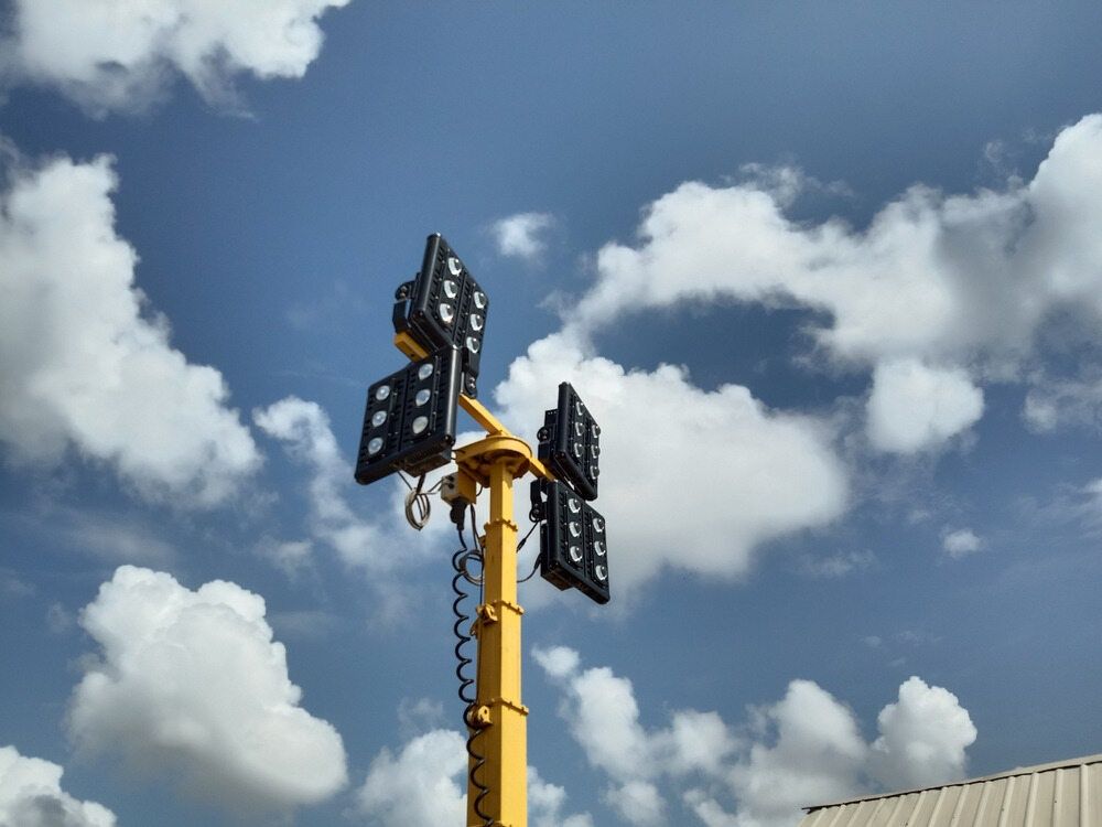 A Yellow Pole With A Bunch Of Lights On It Against A Blue Sky With Clouds — Cool & Secure In Buderim, QLD
