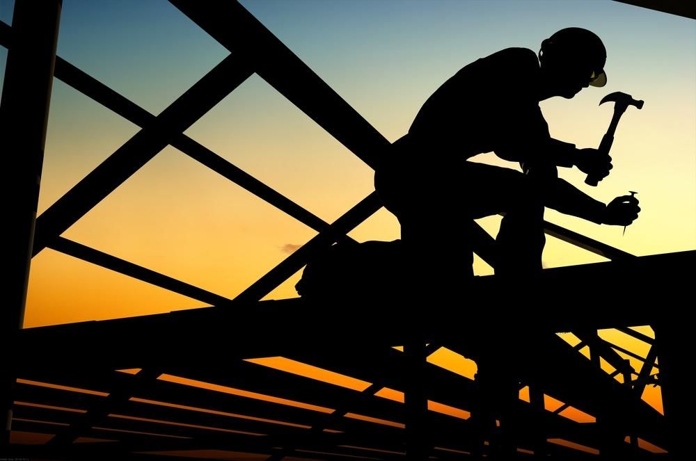 A Silhouette of a Man Working on a Bridge With a Hammer — Lennox Build In Mullumbimby, NSW