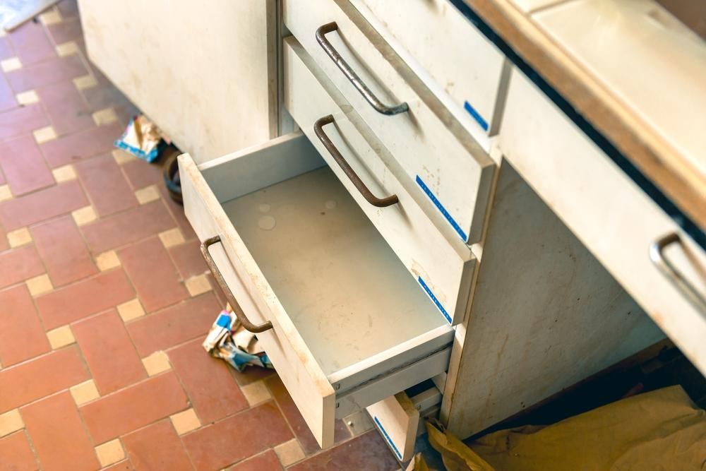 An Empty Drawer in a Kitchen With a Tiled Floor — Lennox Build In Ocean Shores, NSW