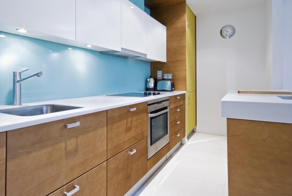 A Kitchen With Wooden Cabinets and White Counter Tops — Lennox Build In Alstonville, NSW