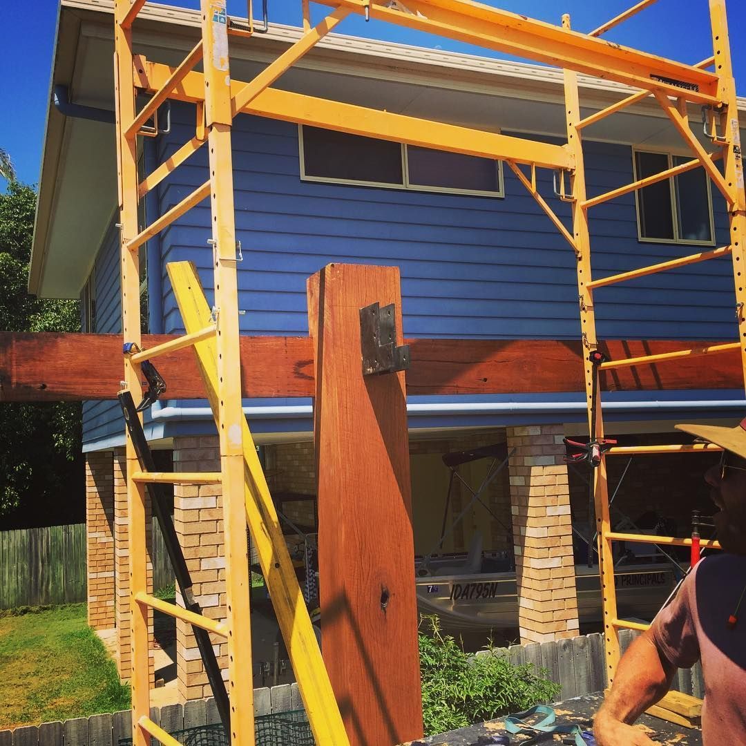 A Man Standing in Front of a House With a Yellow Scaffolding — Lennox Build In Bangalow, NSW
