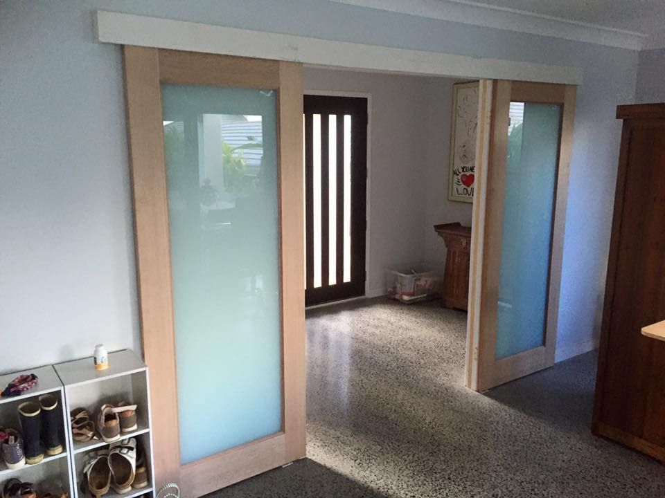 A Hallway With Sliding Glass Doors and a Shoe Rack — Lennox Build In Lennox Head, NSW