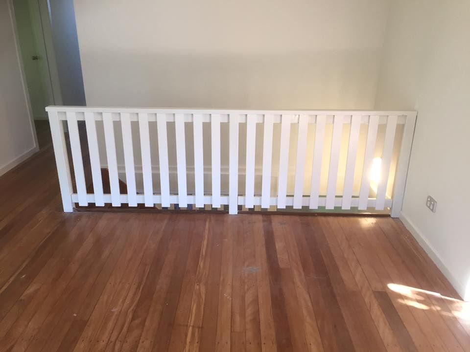 An Empty Room With a Wooden Floor and a White Railing — Lennox Build In Lennox Head, NSW