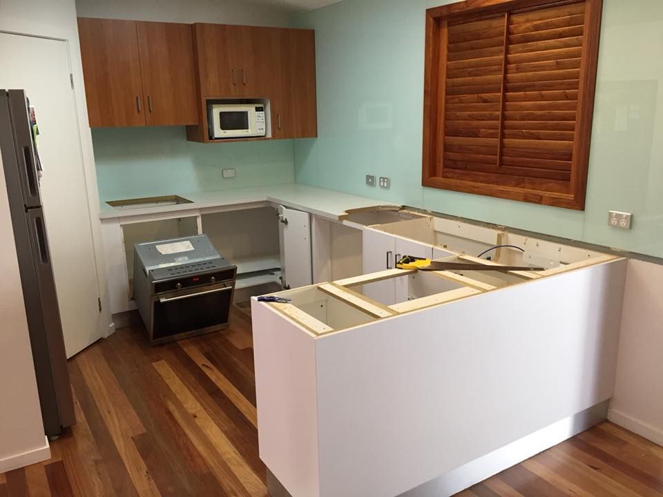 A Kitchen is Being Remodeled With Wooden Cabinets and a Sink — Lennox Build In Lennox Head, NSW