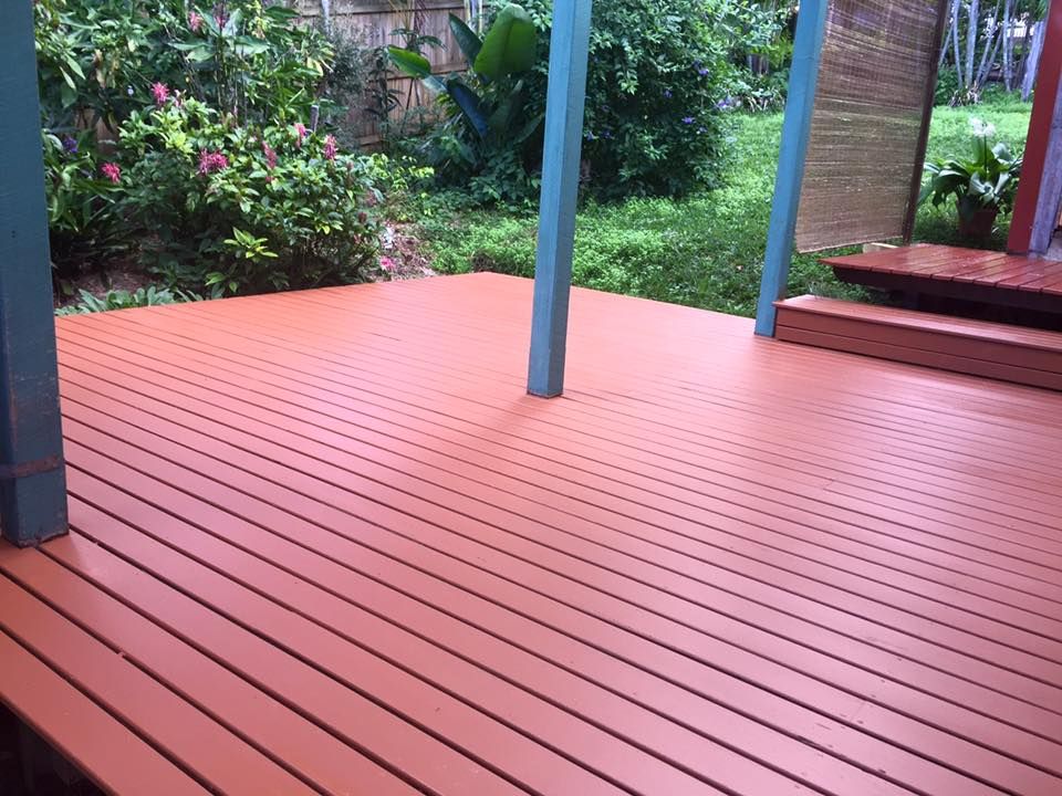 A Wooden Deck With a Blue Roof and Flowers in the Background — Lennox Build In Ballina, NSW