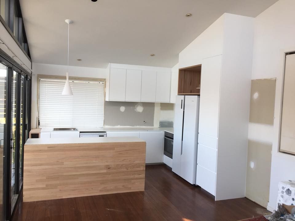 A Kitchen With White Cabinets and a Wooden Counter Top — Lennox Build In Lennox Head, NSW