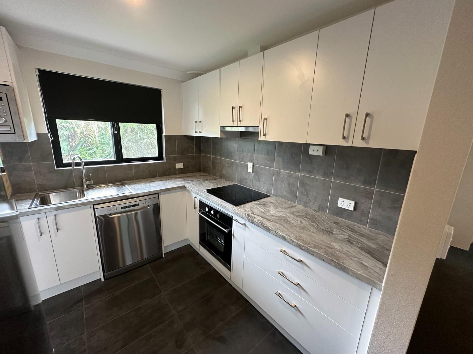 A Kitchen With White Cabinets and Stainless Steel Appliances — Lennox Build In Wardell, NSW