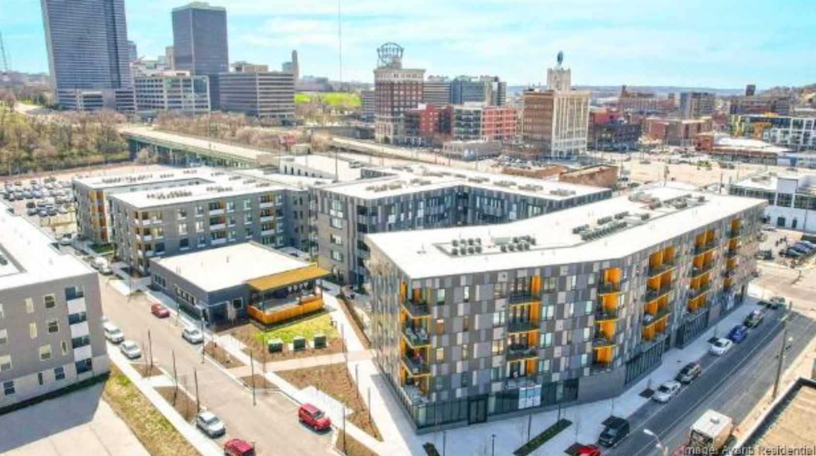 An aerial view of a large apartment building in a city.