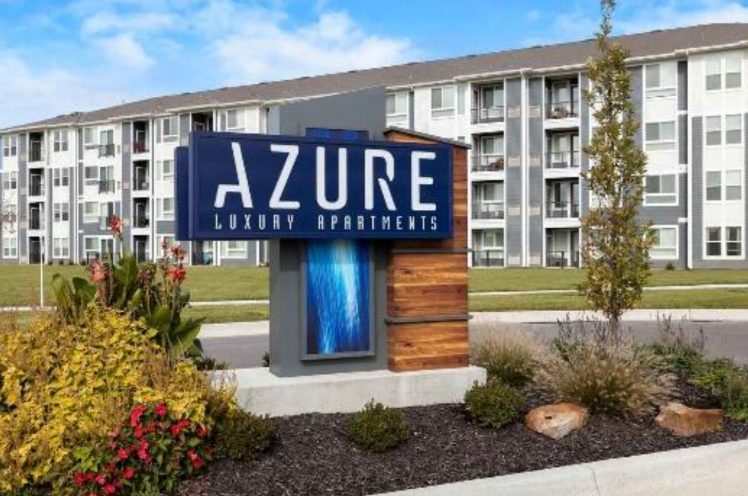 A sign for azure luxury apartments in front of a building
