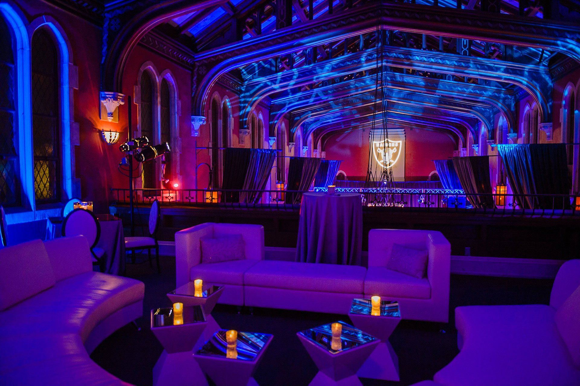 a room with purple lights and a shield on the wall