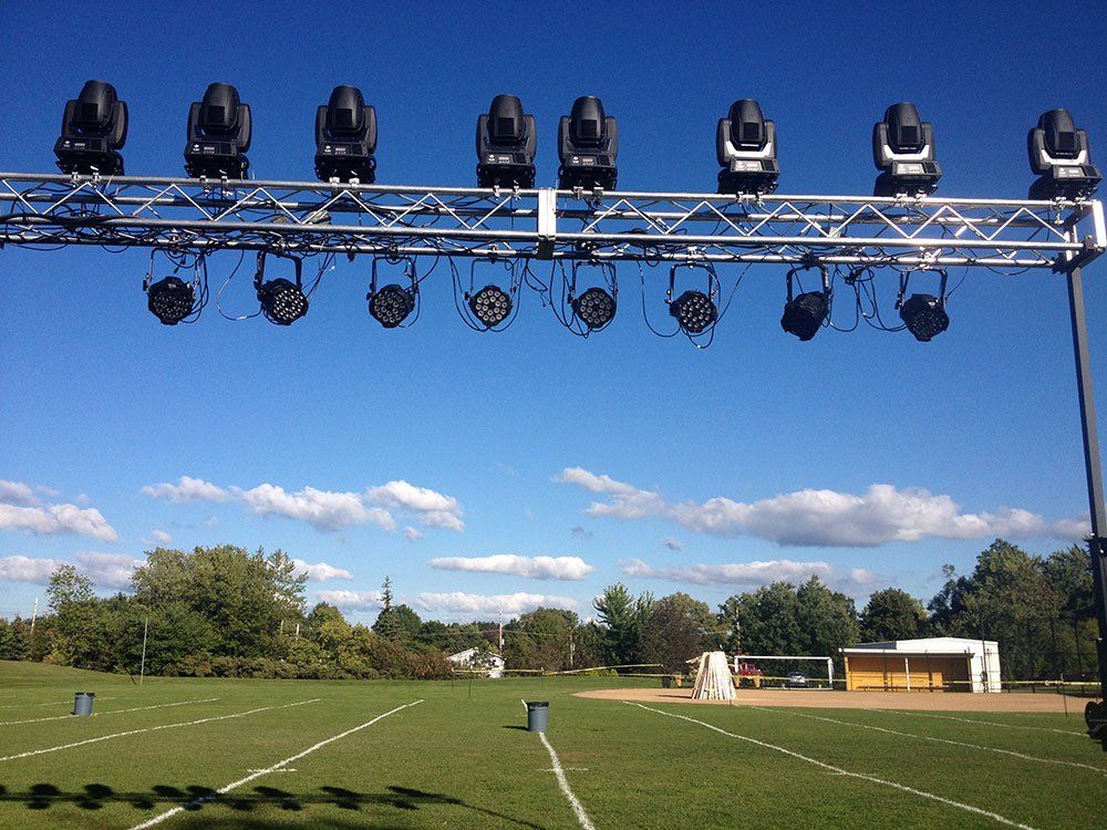 a bunch of lights are hanging from a metal structure