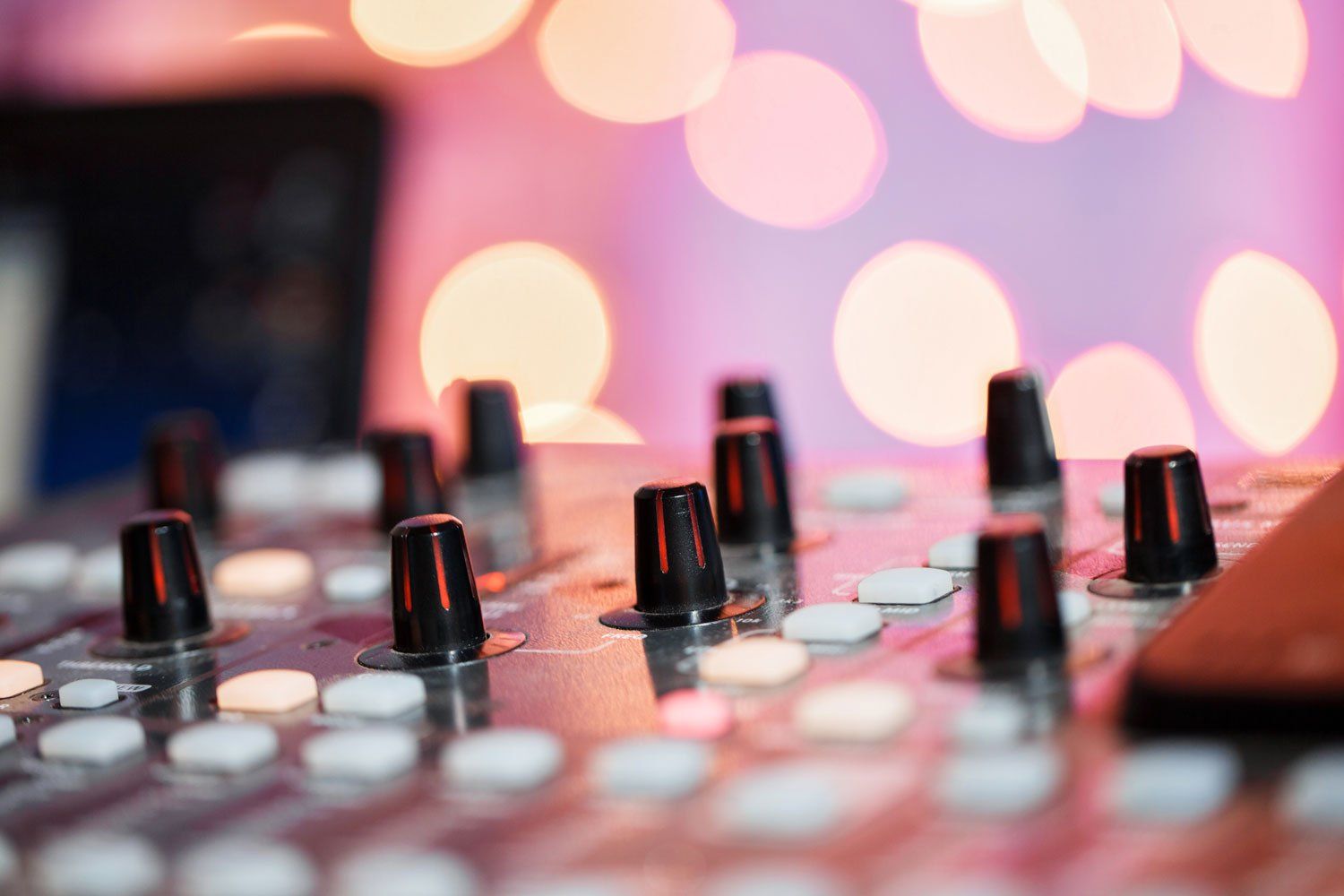 a close up of a mixer with a pink background