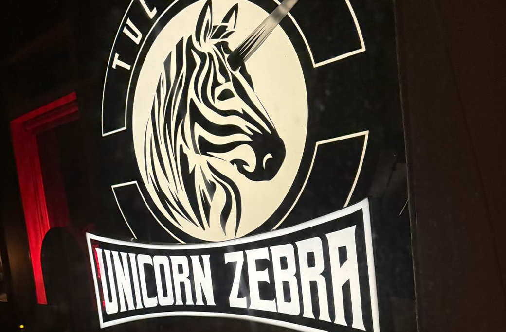 Sign with a zebra-unicorn hybrid image and 