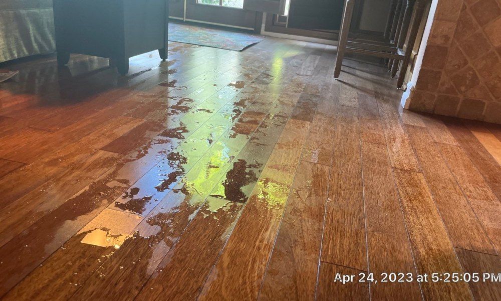 A wooden floor with a lot of stains on it.