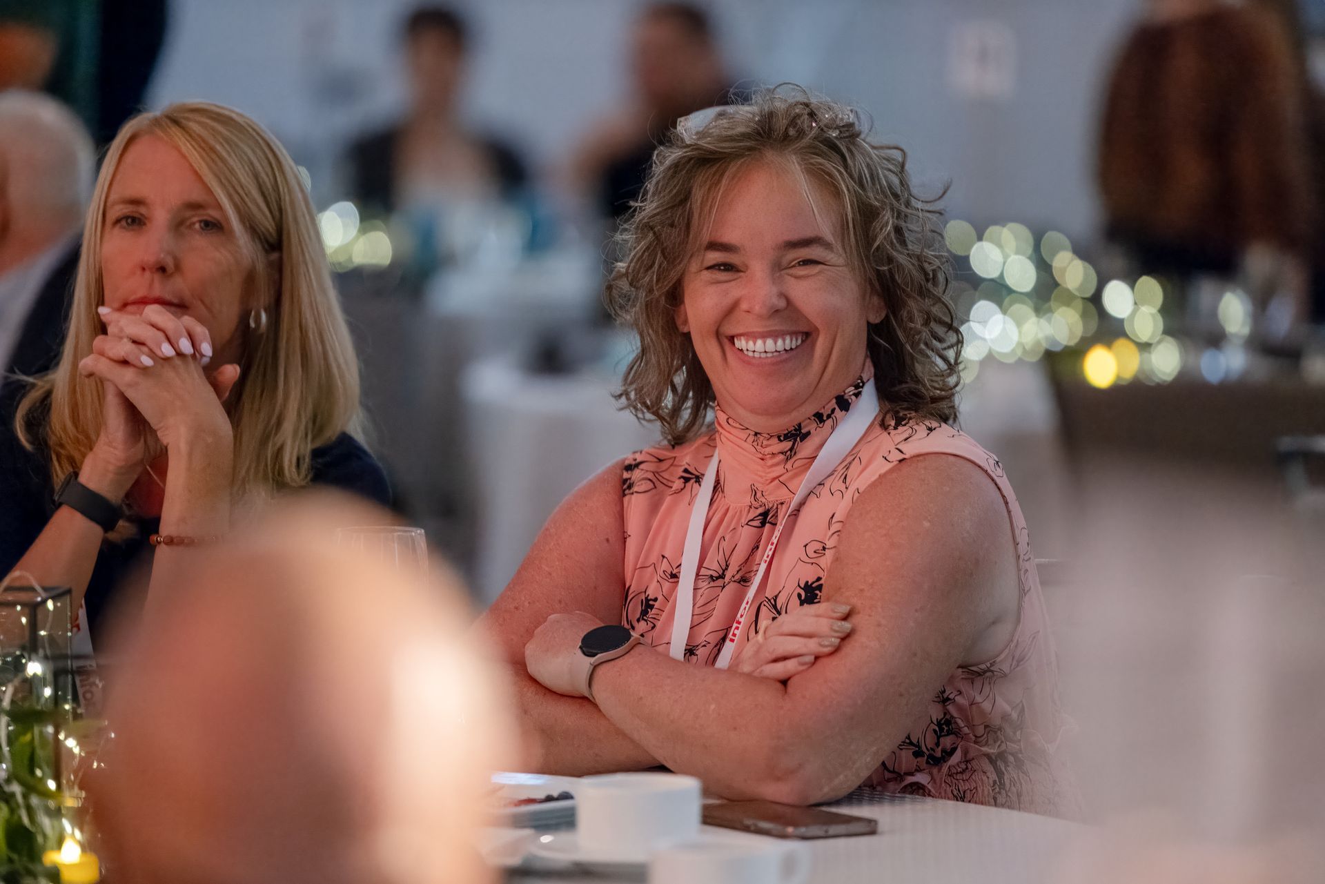 Two women, one smiling, one looking serenely at the camera