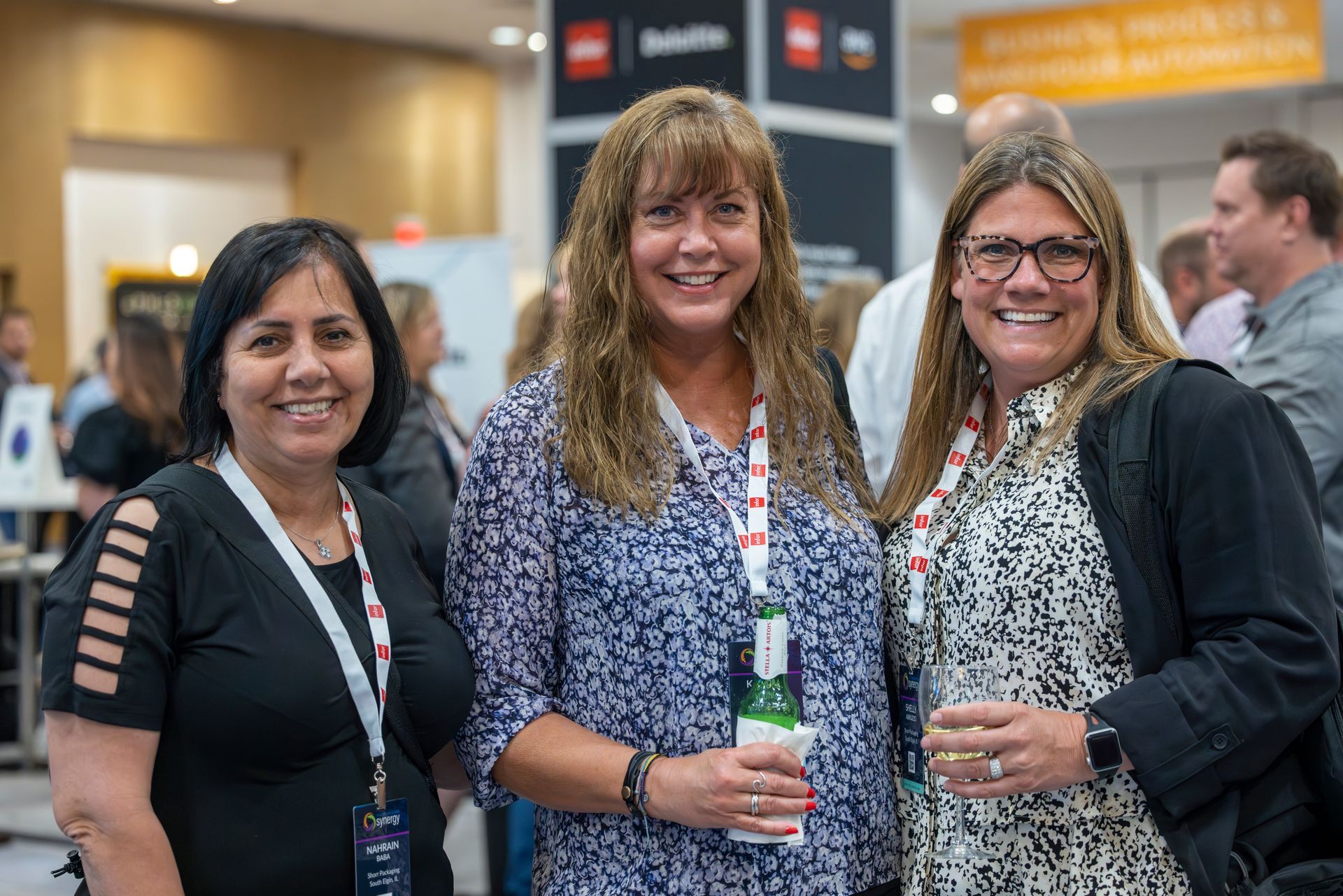 Three women smile at the camera
