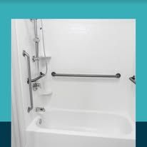 White accessible bathtub with grab bars and showerhead.