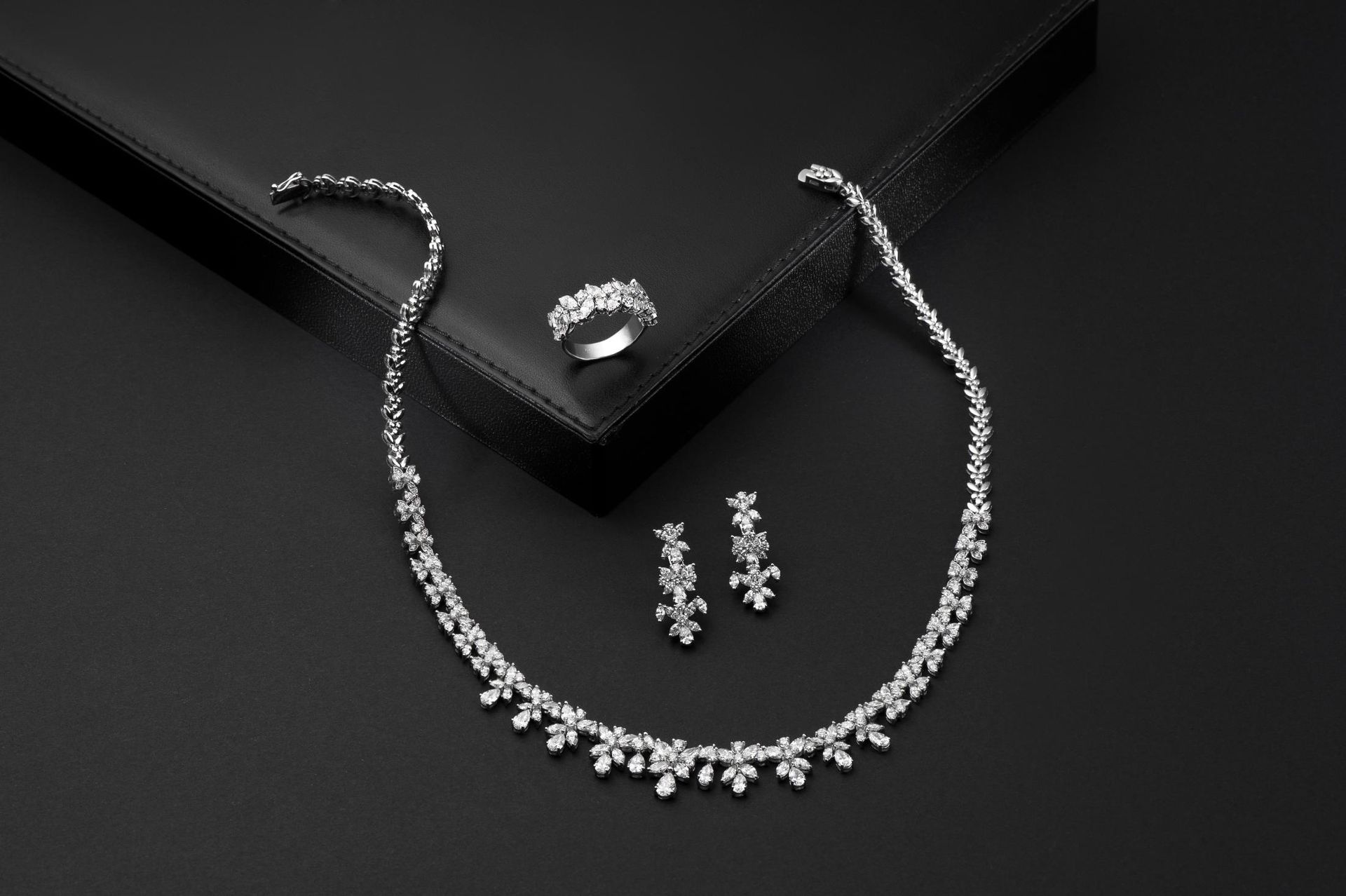 A diamond ring is sitting in front of a computer screen.
