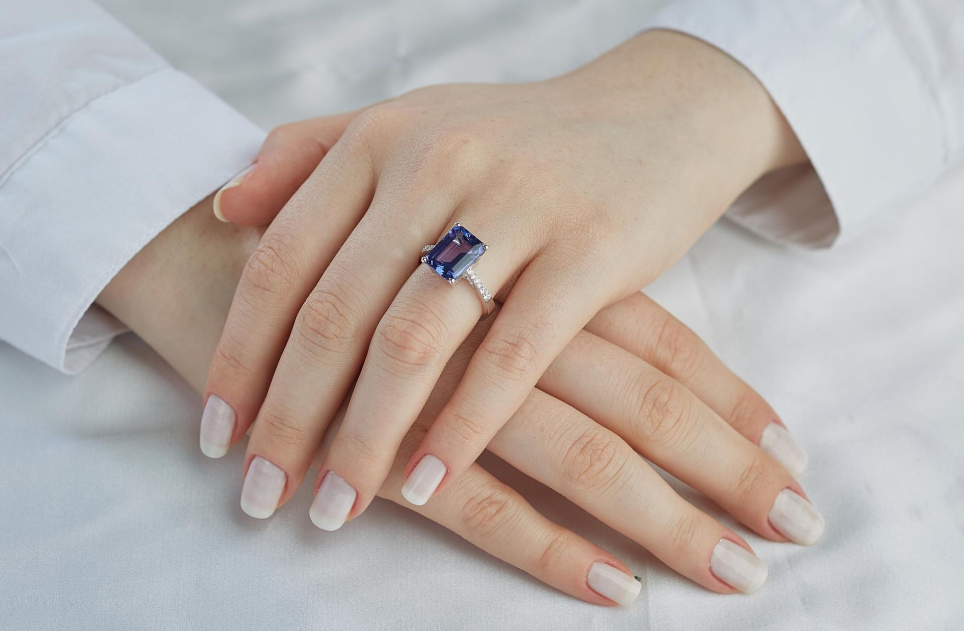 A woman is wearing a ring on her left hand.