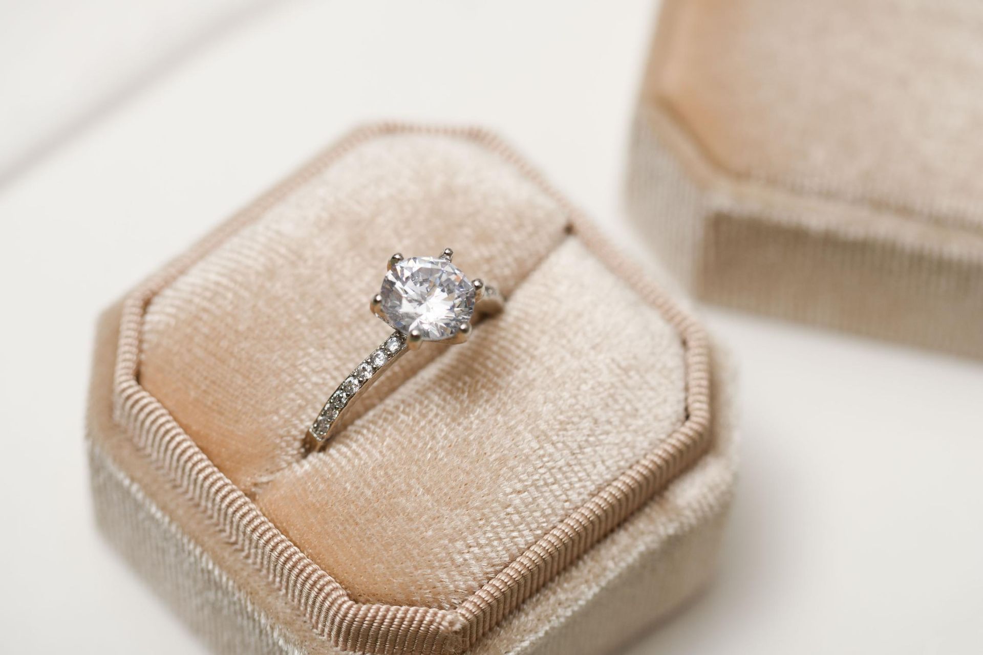 A diamond ring is sitting in a velvet box.