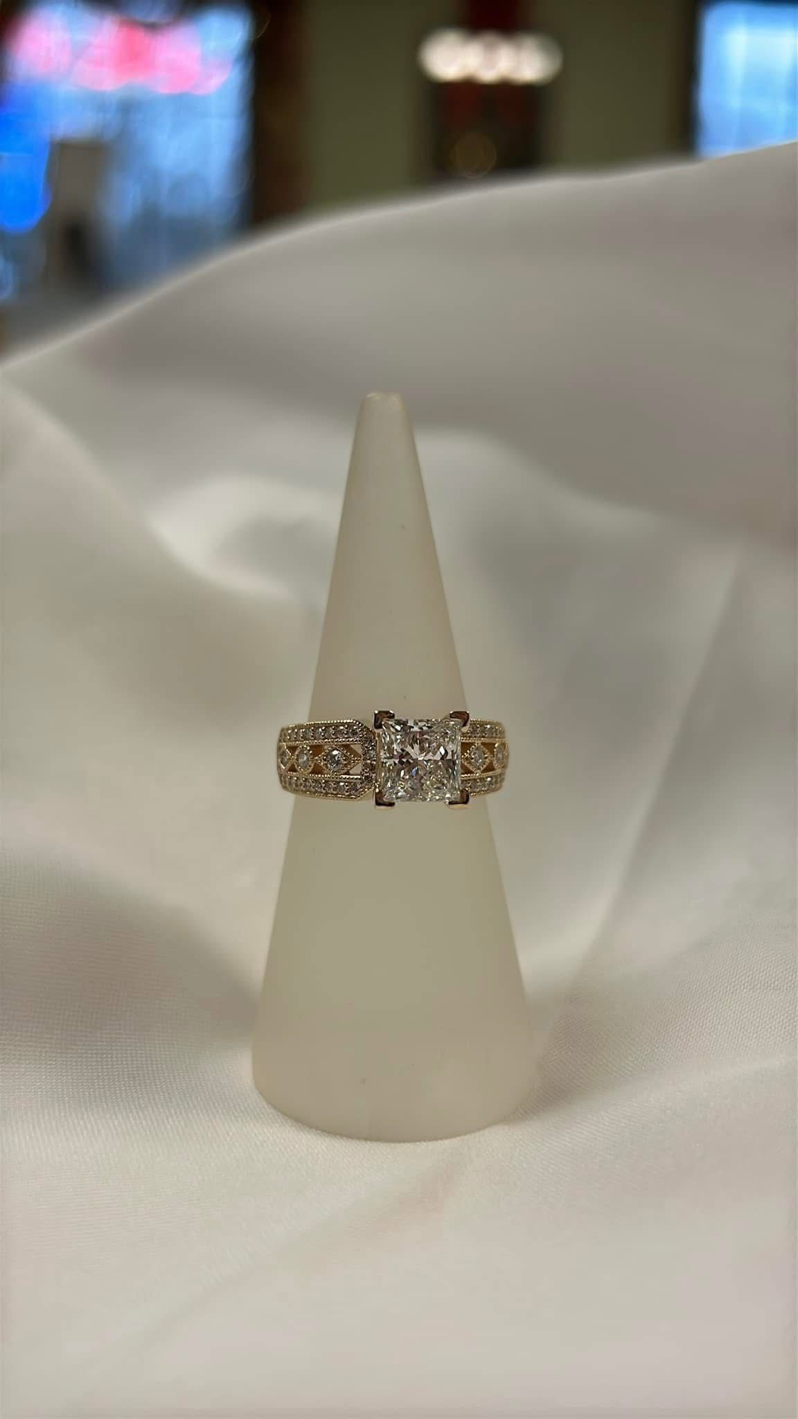 Custom made diamond engagement ring with milgrain.