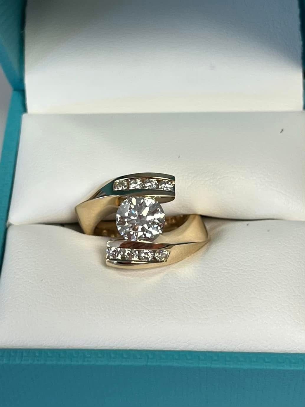 Fancy yellow gold bypass style engagement ring.