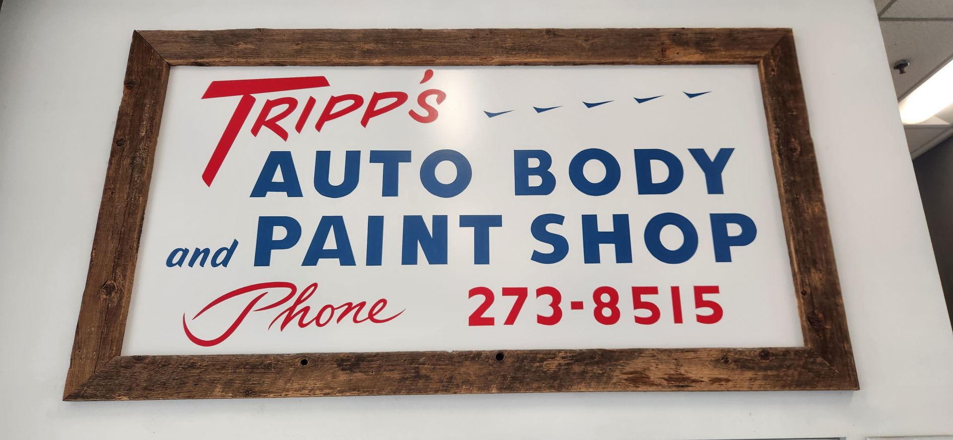 Framed sign for Tripp’s Auto Body and Paint Shop with phone number 273-8515 | Tripp's Auto Body