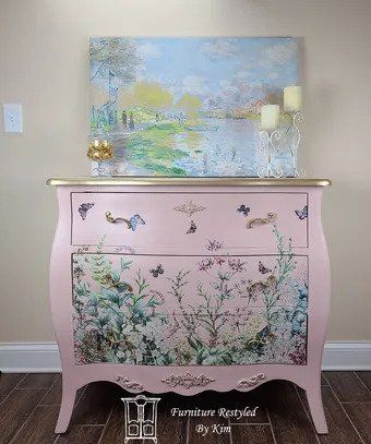 pink furniture with candle stands and painting on top