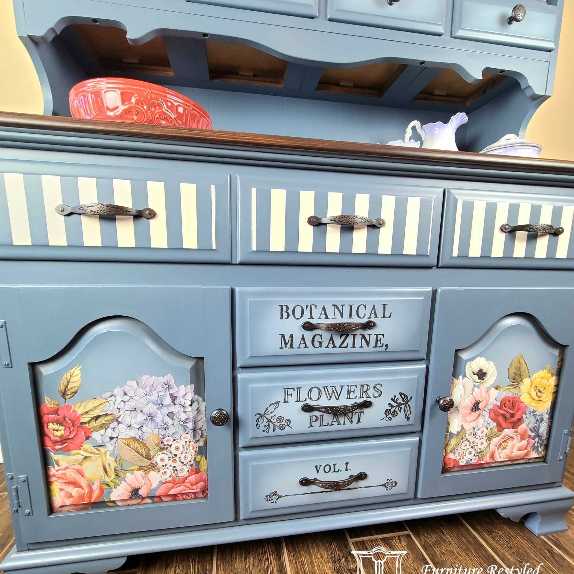 blue farmhouse kitchen cabinet with floral and wording paintings