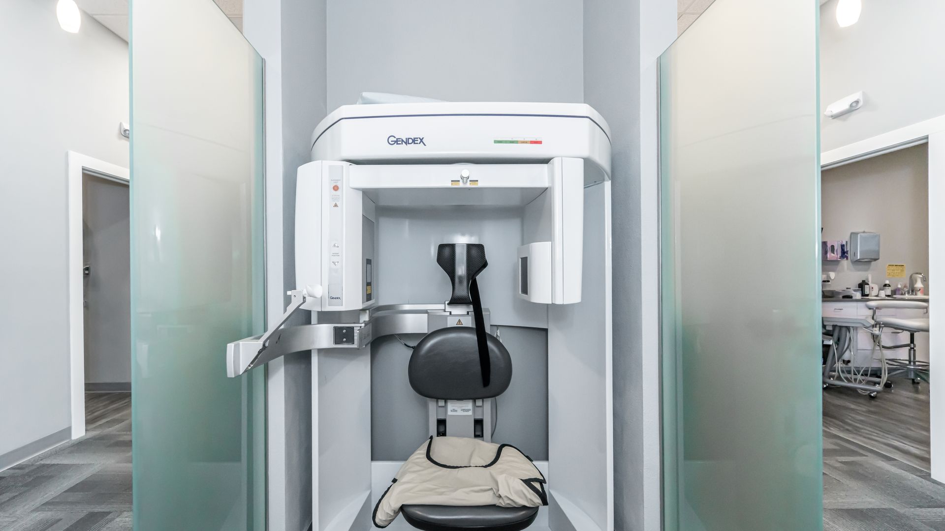 A dental office with a chair and a machine.