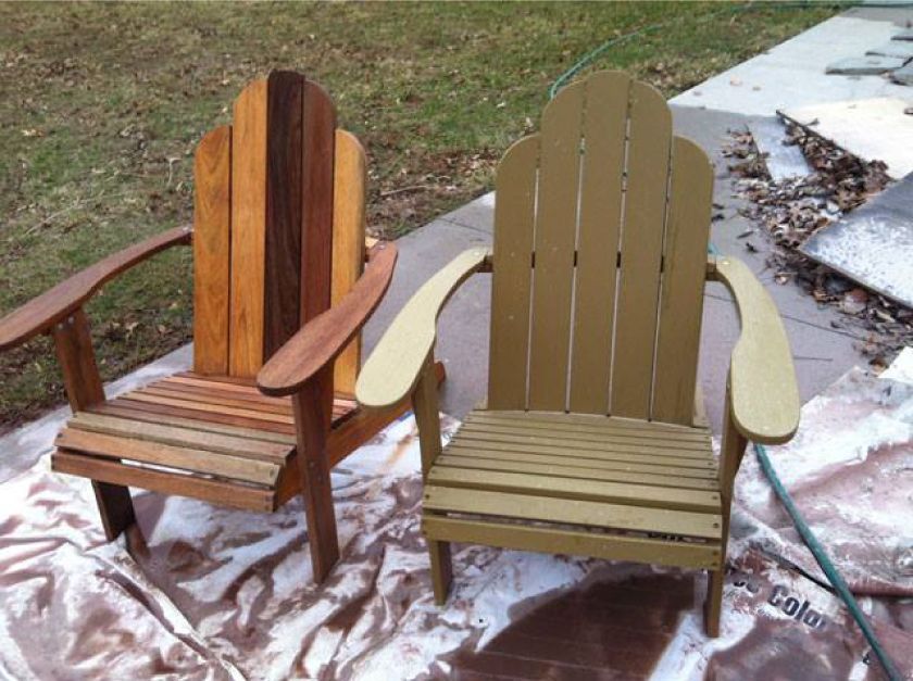 Two wooden adirondack chairs are painted different colors