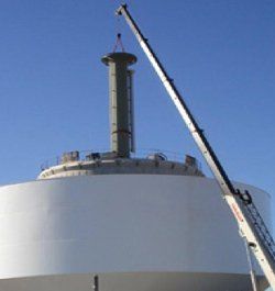 Hoisting Service — Crane Lifting A Huge Metal in Lawrence, KS