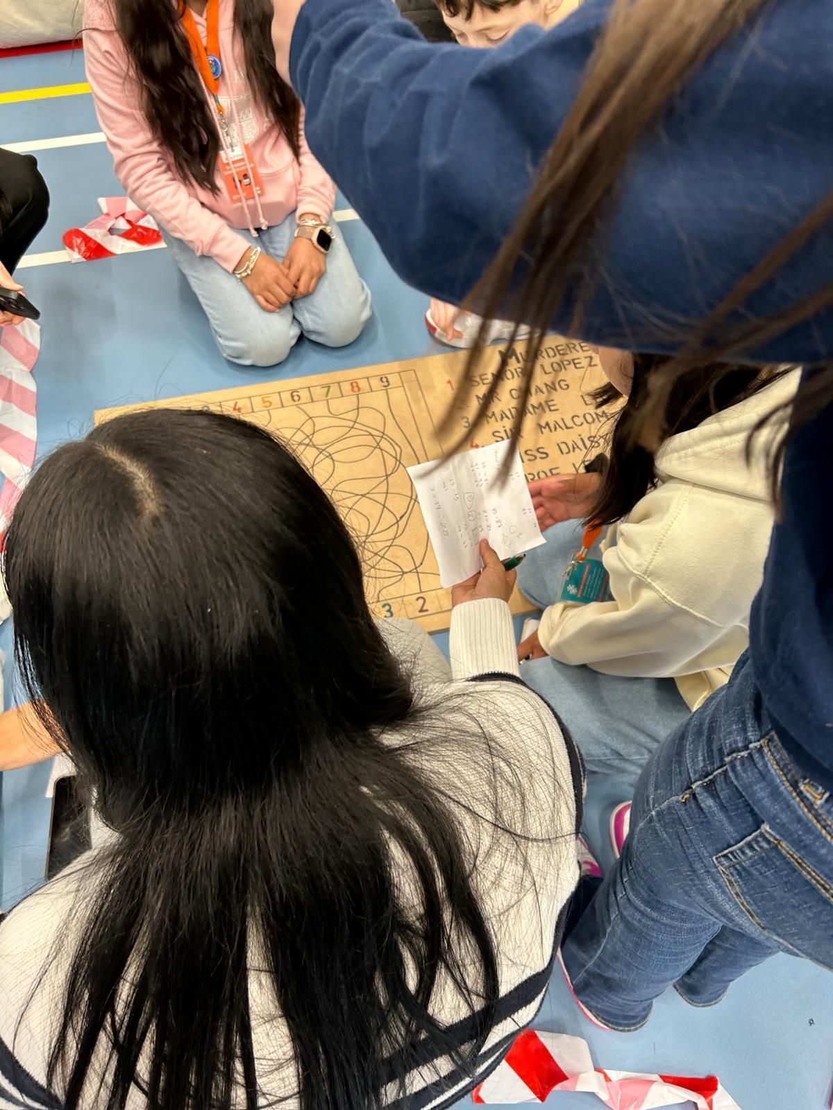 A group of people are sitting in a circle on the floor.