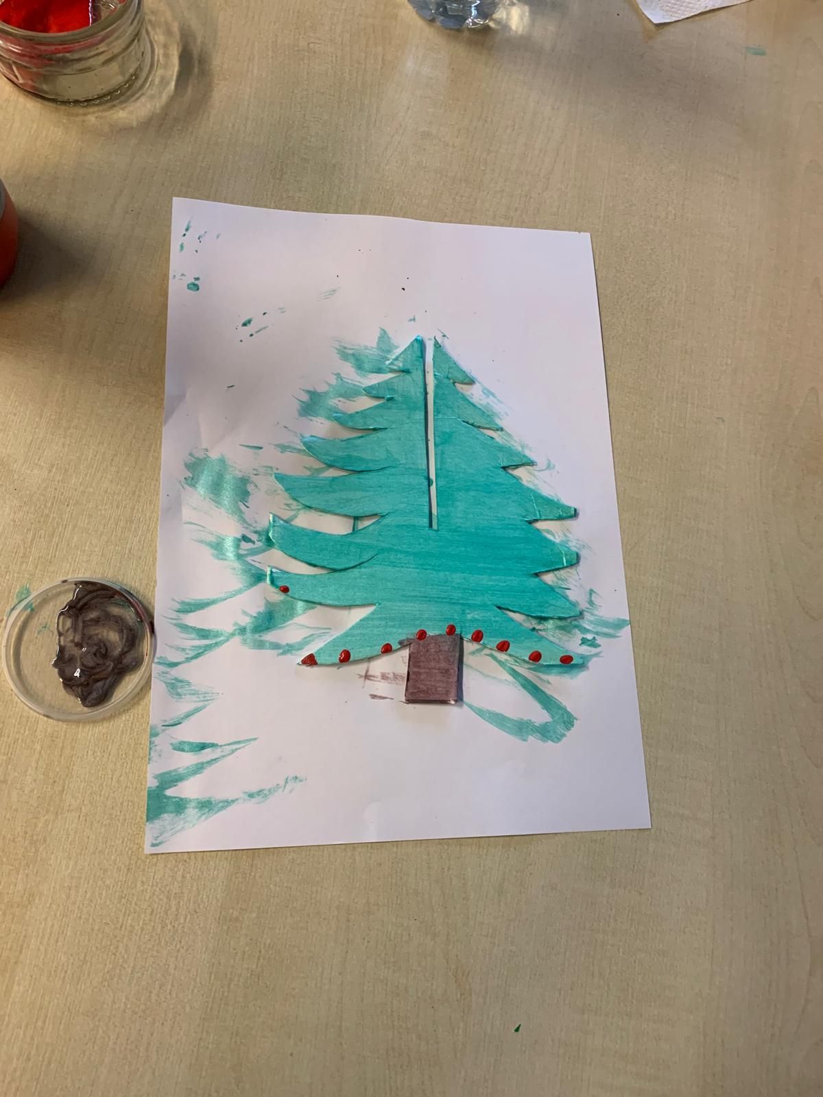 A child 's drawing of a christmas tree on a piece of paper