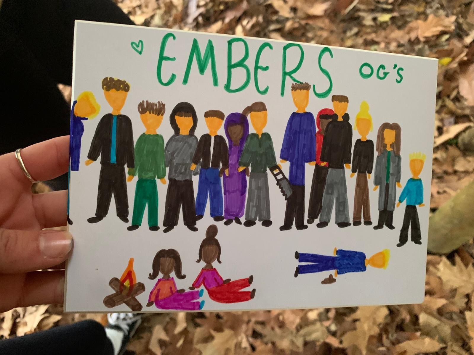 A person is holding a card that says embers og 's