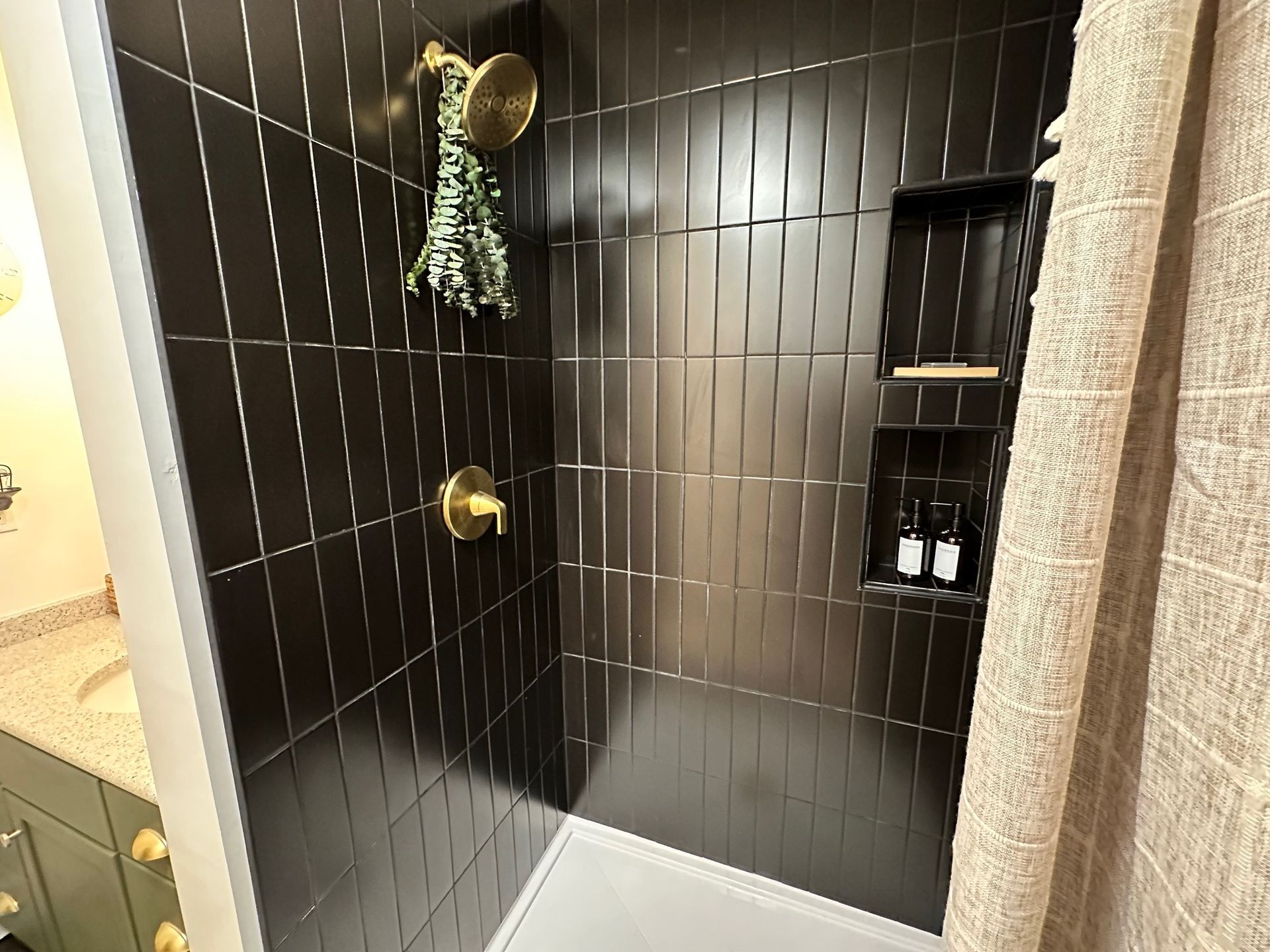 Vertical black subway tile shower remodel