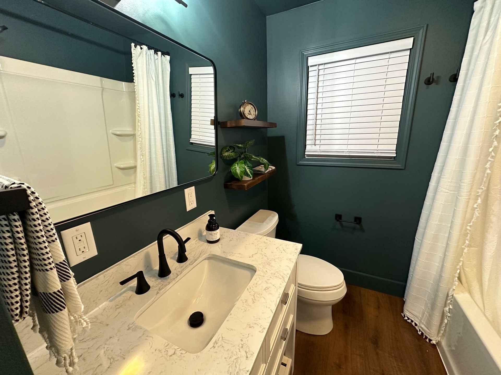 Modern monotone bathroom remodel in the color Still Water by Sherwin Williams