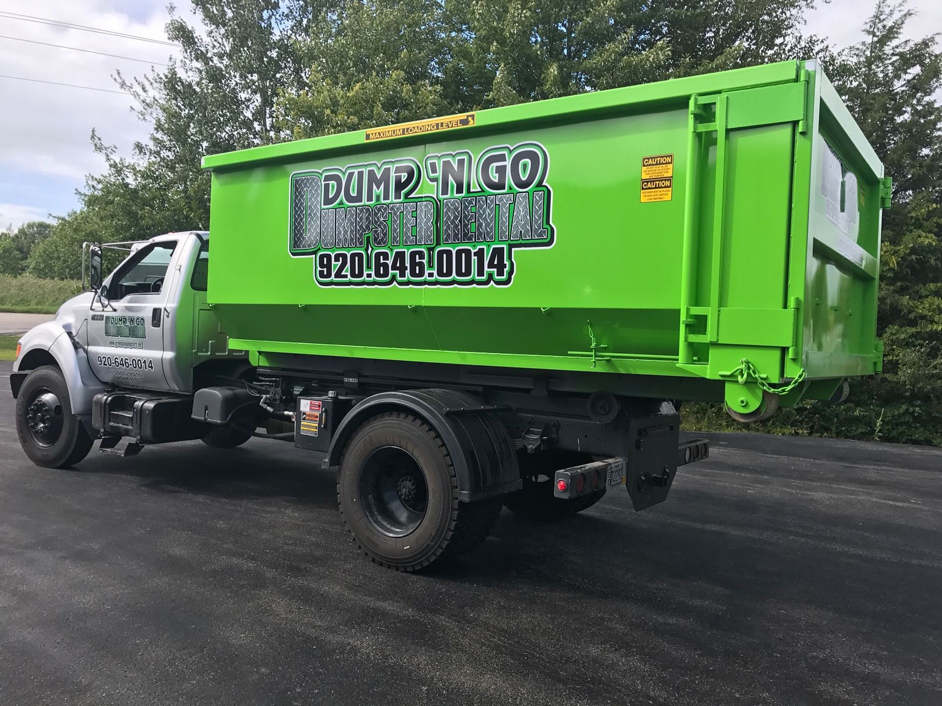 Green Dumpster truck with 
