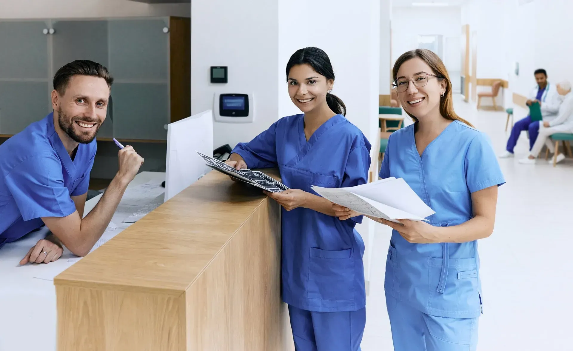 A group of nurses are standing next to each other in a hospital. A group of nurses are standing next to each other in a hospital.