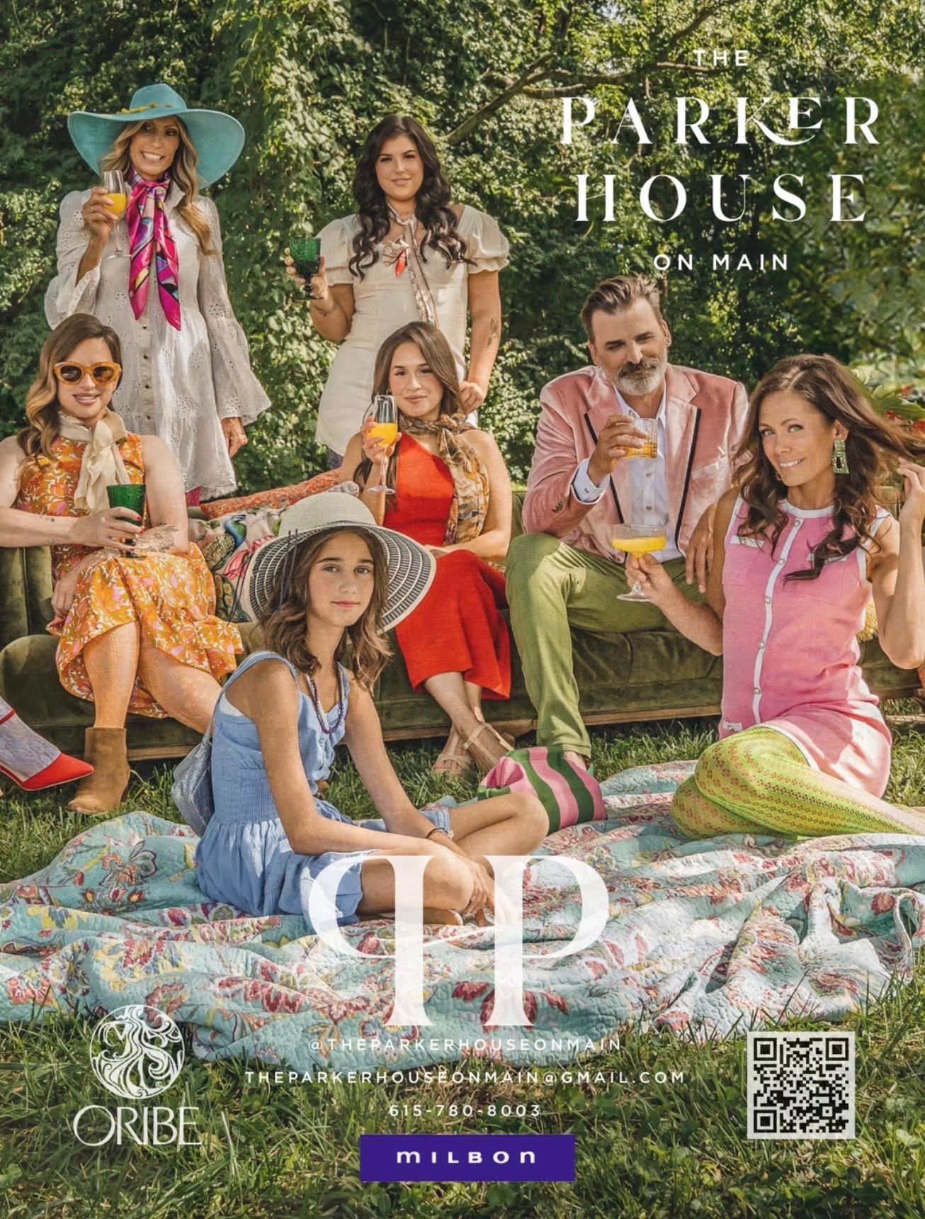 Group of people in a garden, holding drinks, wearing bright clothing. Parker House on Main logo.