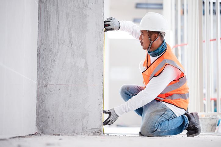 Brick wall with gray mortar covering a metal corner bead.