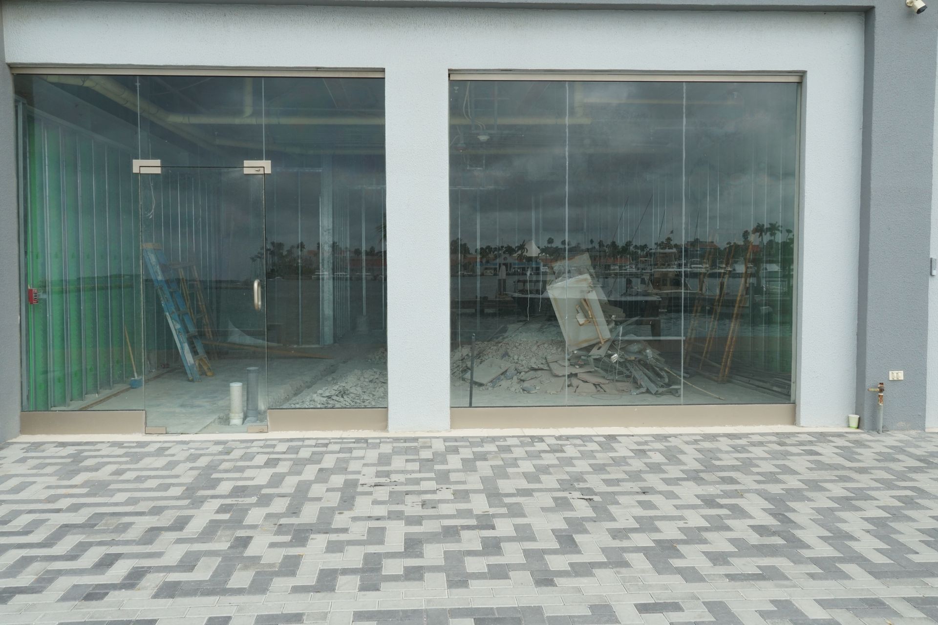 Exterior staircase between beige apartment buildings with metal railings.