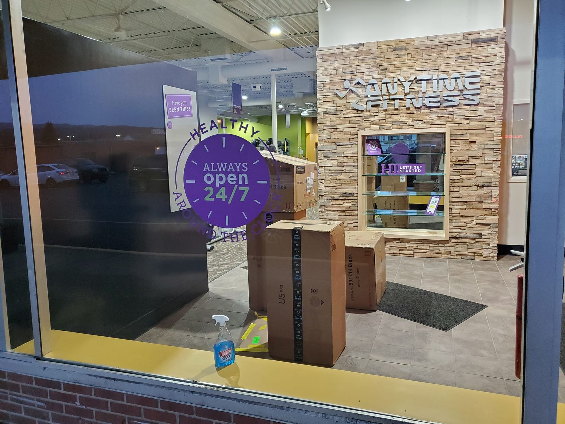 A store front with boxes and a sign that says always open 24/7